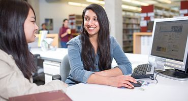 A librarian helping a student with research